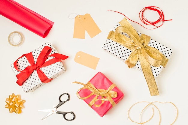 Overhead view of stationery supplies; gift boxes and blank labels on white background