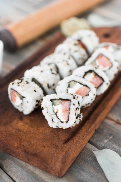 An overhead view of sushi on wooden tray