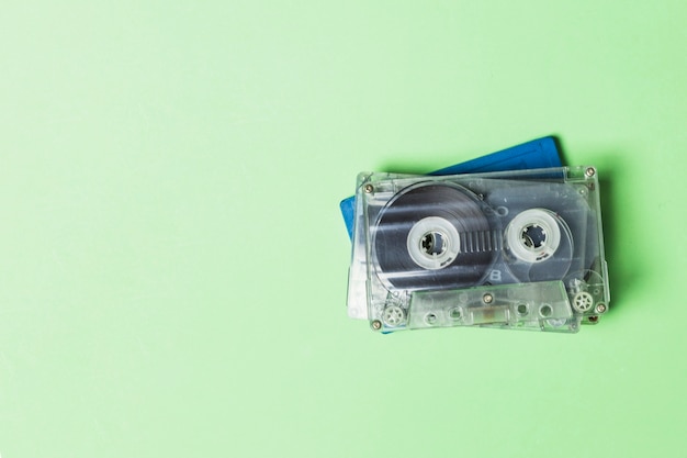 Overhead view of transparent cassette tape on green backdrop