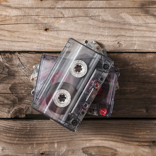 Free photo overhead view of transparent cassette tape on wooden table