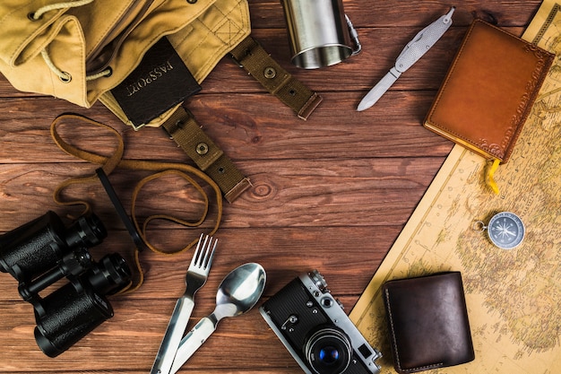 Overhead view of travelling equipments over wooden desk