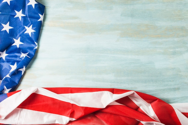 An overhead view of usa flag with stars and stripes on wooden textured background