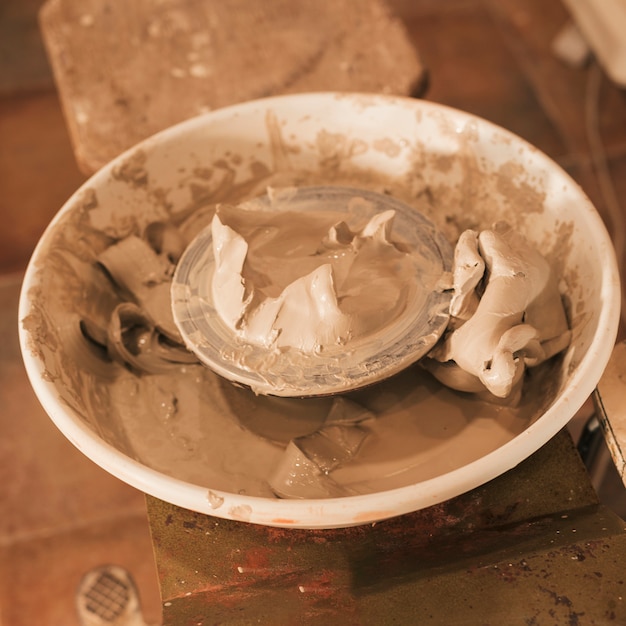 An overhead view of used wet clay on pottery wheel's
