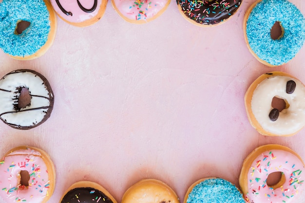 Free photo overhead view of various donuts forming frame