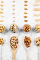 Free photo overhead view of various nut food on marble backdrop