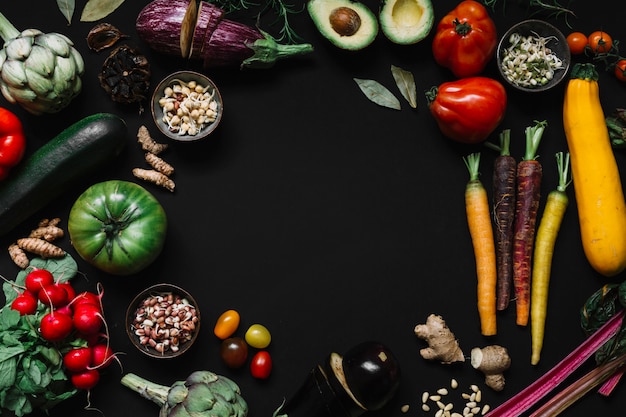 An overhead view of vegetables on black background