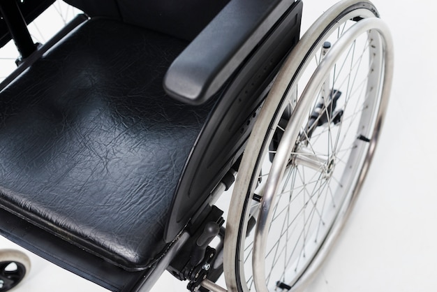 An overhead view of a wheelchair on white backdrop