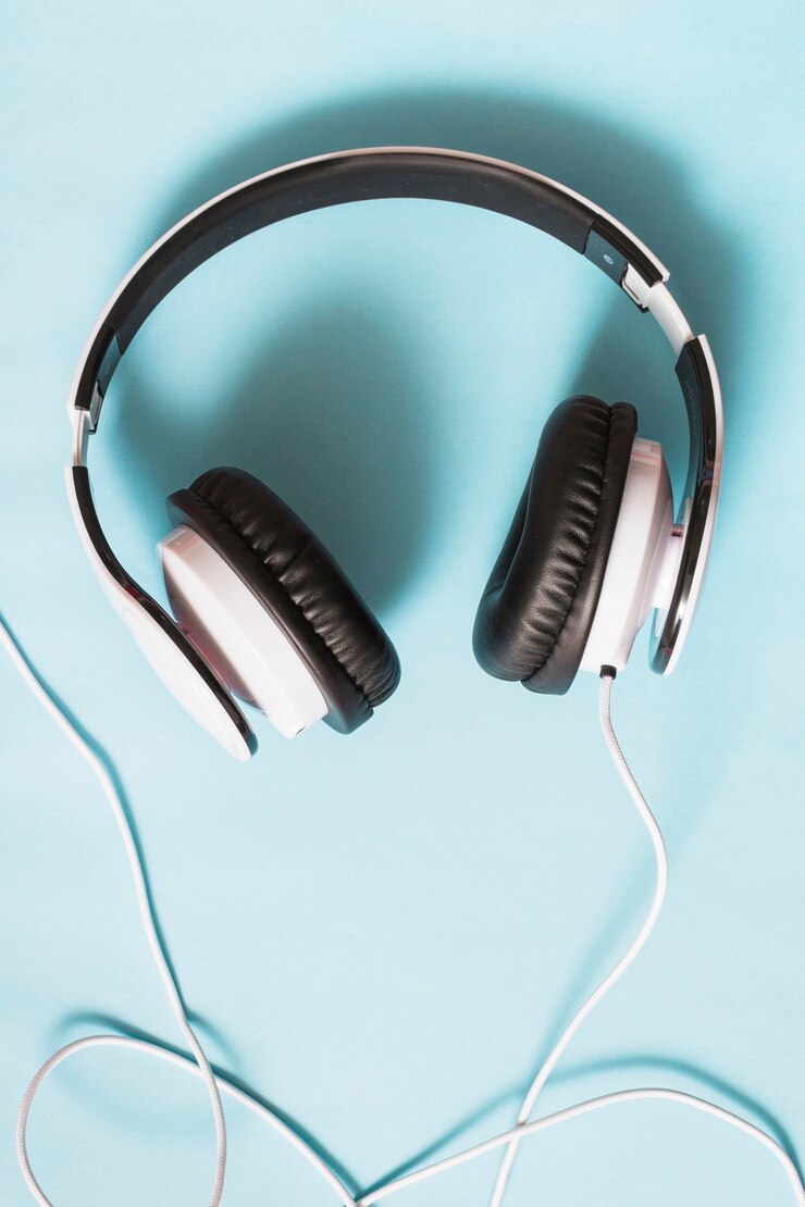 Free Photo an overhead view of white headphone against blue background