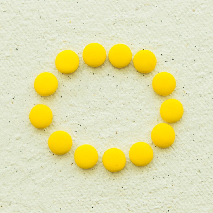Free Photo overhead view of yellow candies forming circular frame