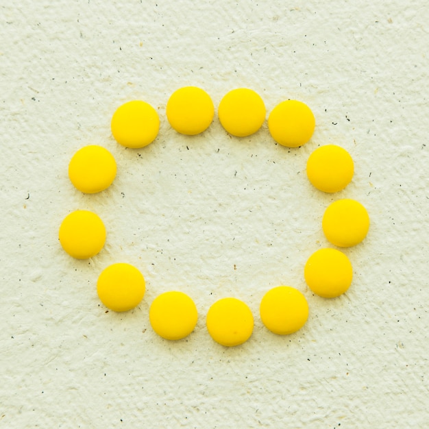 Overhead view of yellow candies forming circular frame