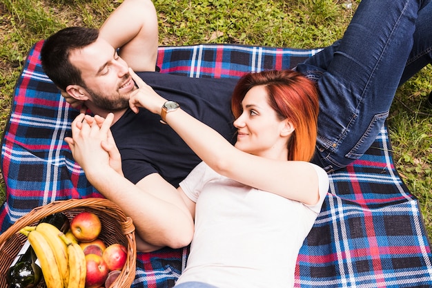 An overhead view of young couple relaxing at picnic