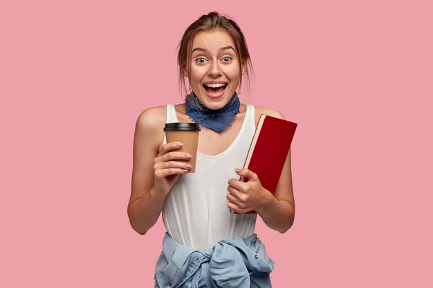 Overjoyed amazed female student has fun with groupmates during coffee break