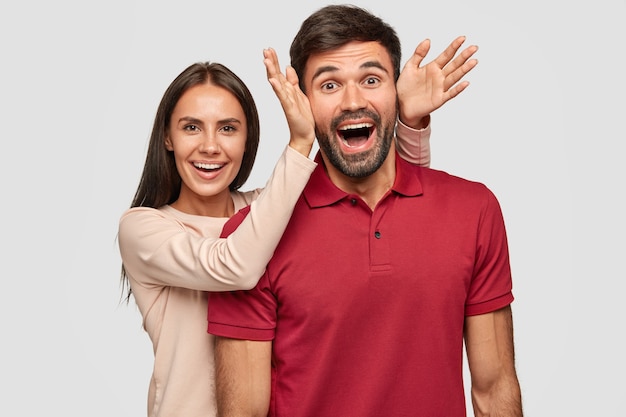 Overjoyed funny girlfriend and boyfriend foolish together, have happy expressions