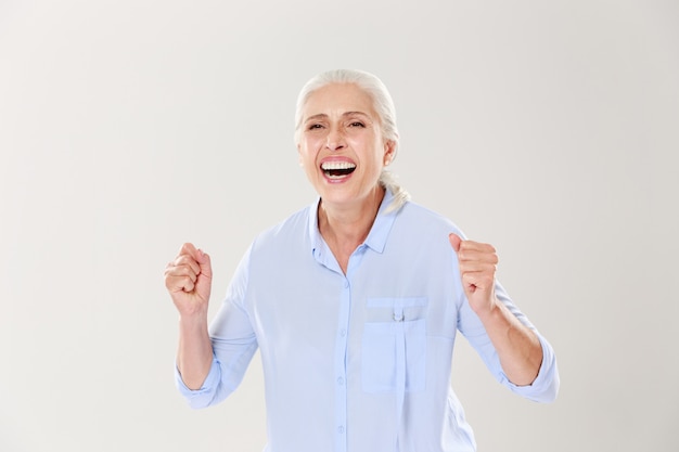 Overjoyed old woman, celebrating the vin