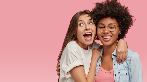 Overjoyed young European woman with widely opened mouth