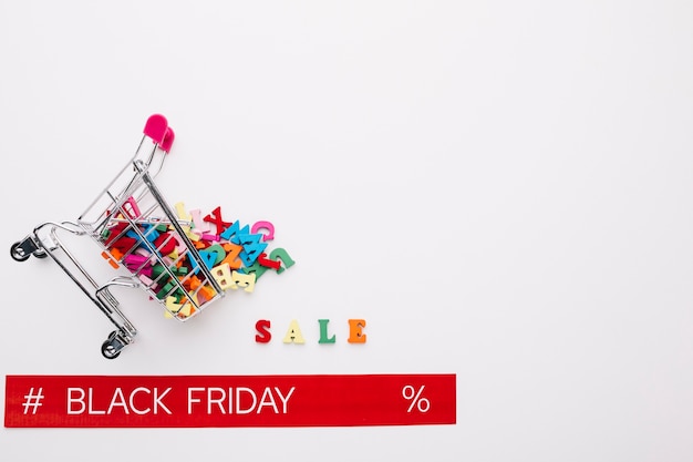 Overturned shopping cart with black friday ribbon