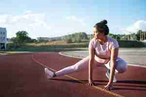 Free photo overweight woman warming up to exercise outside