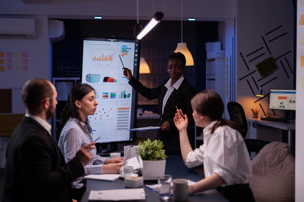 overworked businesswoman with dark skin brainstorming financial strategy