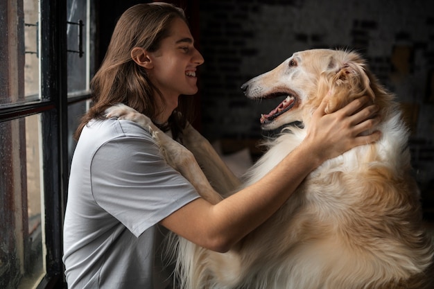 Owner spending time with their greyhound dog