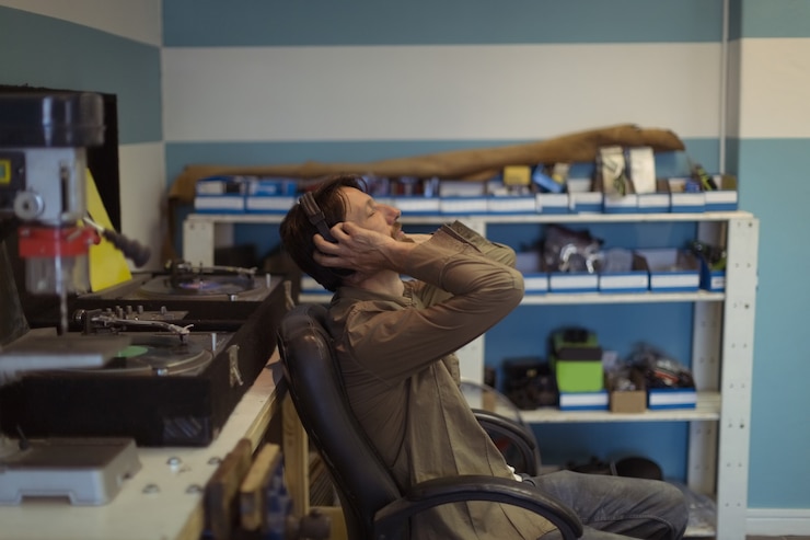 Free Photo owner with eyes closed listening music at bicycle workshop