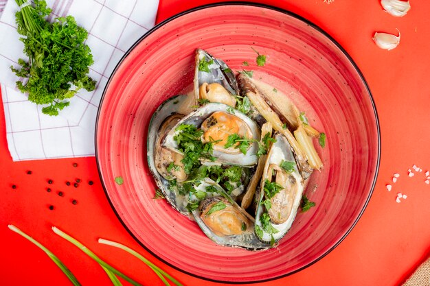 Oysters in plate topped with herbs