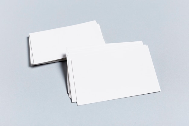 Pack of blank business cards on blue table