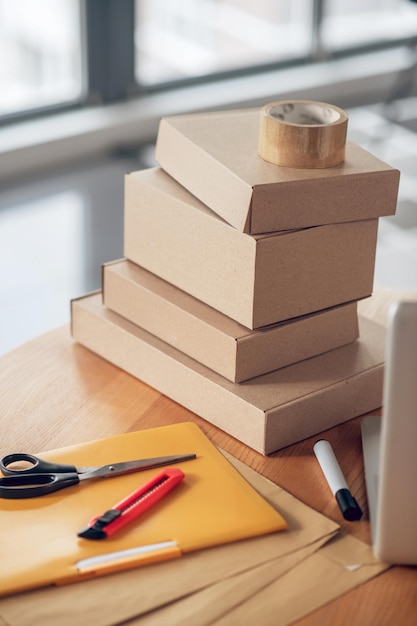 Packages stacked on a round wooden office desk