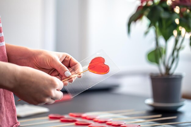 Packaging of red lollipops in the shape of hearts