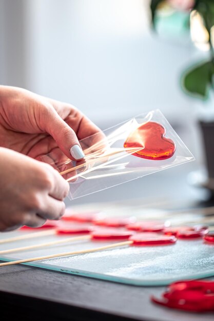 Packaging of red lollipops in the shape of hearts