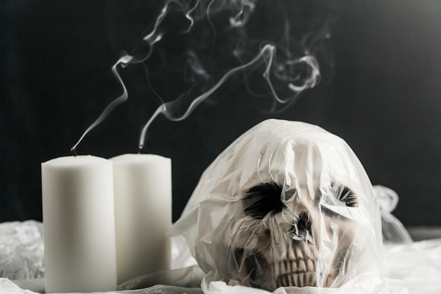 Packed in plastic bag skull with white candles