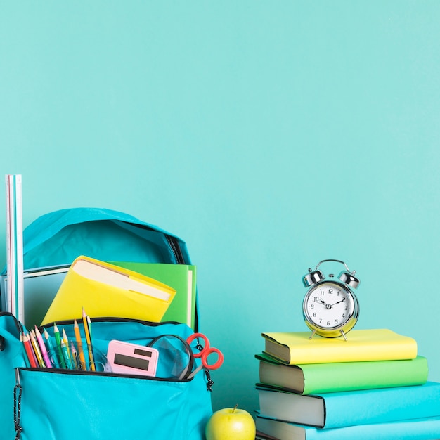 Packed school bag and alarm clock for early wake up