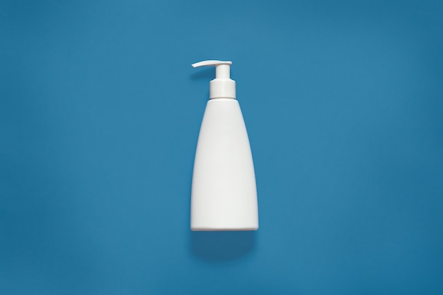 Packing with liquid soap isoaltedon blue studio, cosmetic white empty plastic bottle with clipping path, front view of cosmetic container with copy space for advertisment. Mock up.