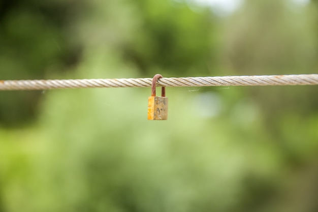 Padlock hanging on a rope