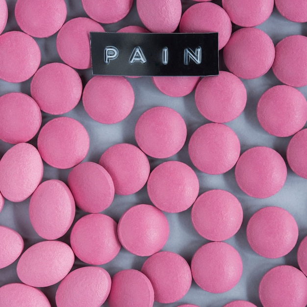 Pain label over the pink circular pills