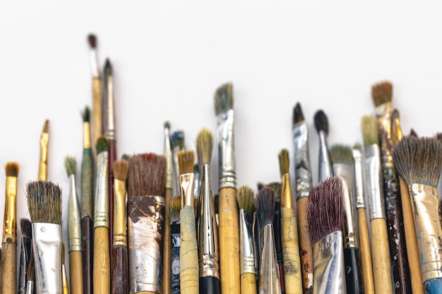 Paint brushes of different sizes on a white background isolated