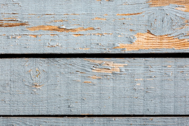 Paint chipping on wooden surface