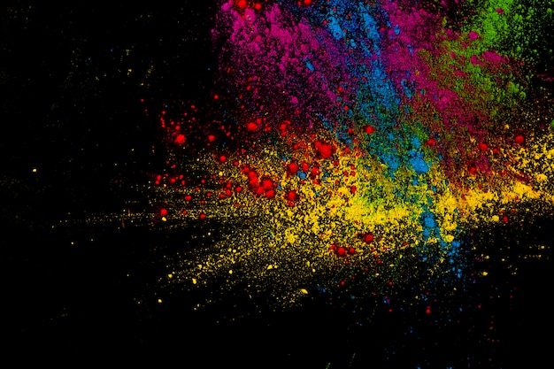 Paint colorful powder explosion over dark surface