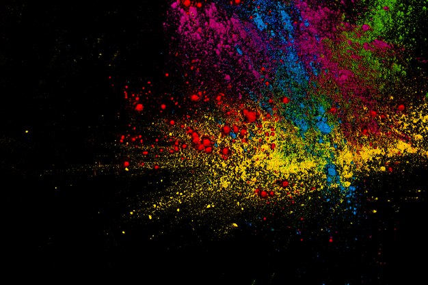 Paint colorful powder explosion over dark surface