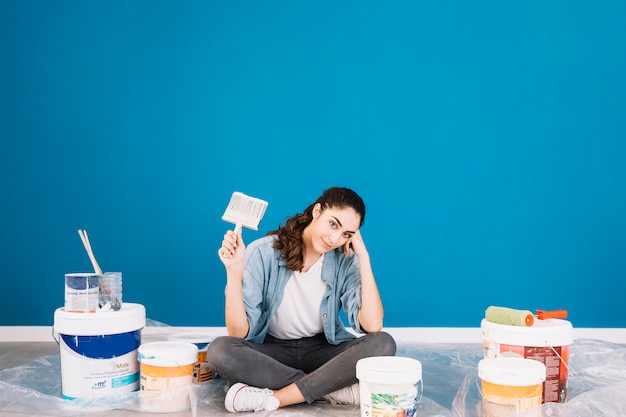 Paint concept with sitting woman and buckets