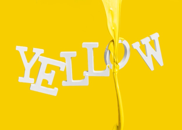 Free photo paint dripping on floating word yellow