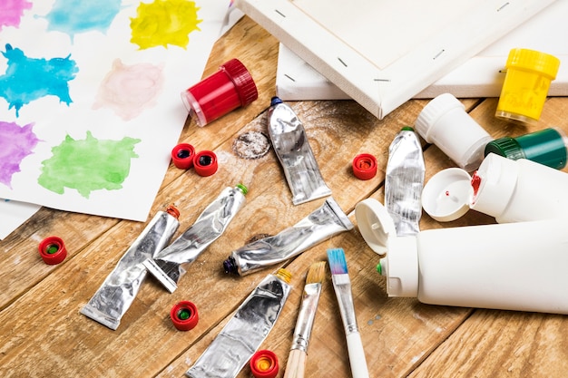 Free photo paint essentials on wooden surface