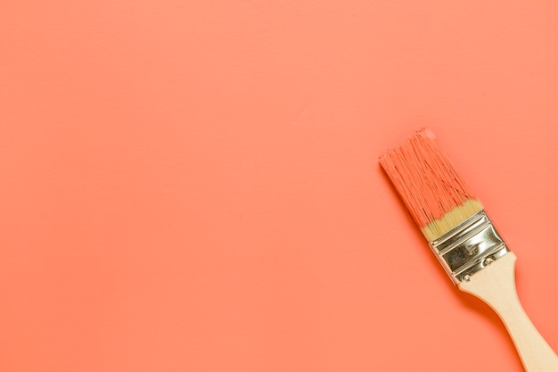 Paintbrush on orange background
