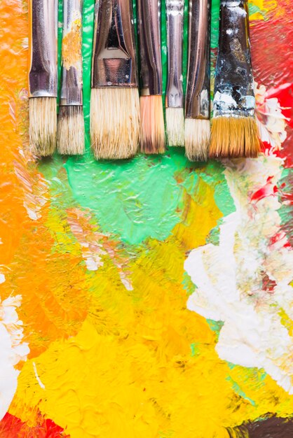 Paintbrushes on strokes of paint