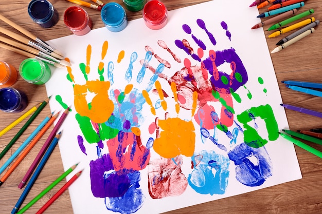 Painted handprints with artistic equipment 