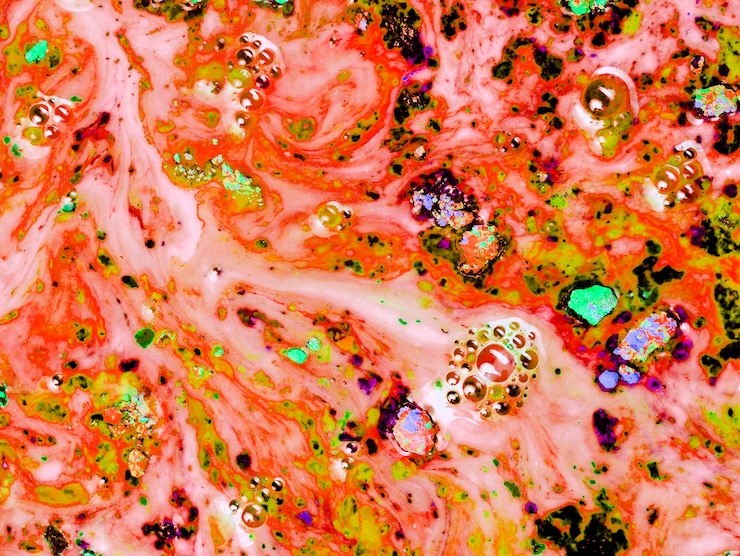 Free Photo painted orange powder in black water