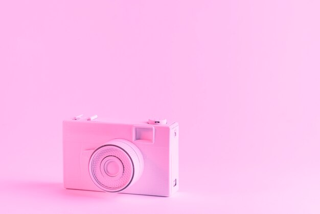 Painted pink camera against pink background