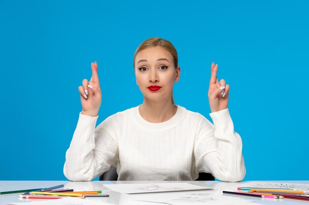 Painter lovely young pretty girl with red lipstick with crossed fingers hoping for something