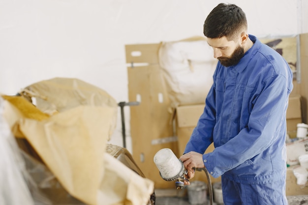 Free photo painting of machine parts. white paint. angle grinder.