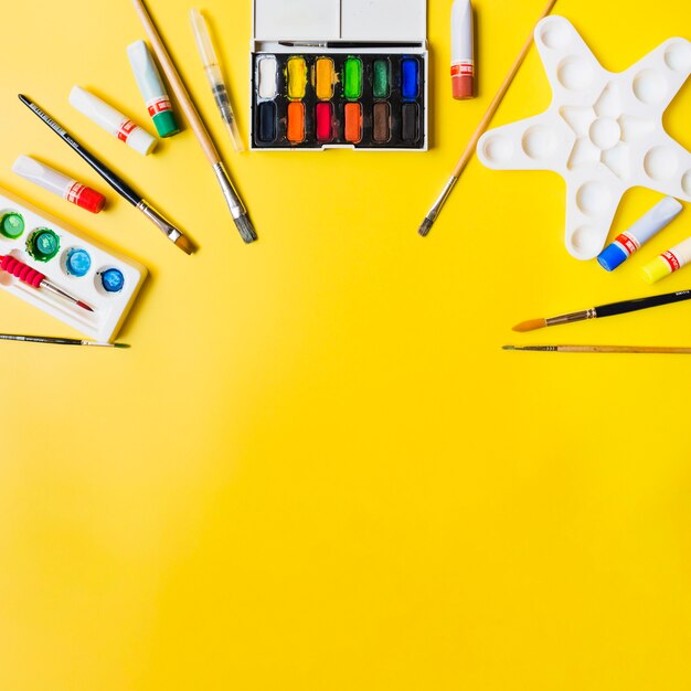 Painting supplies on yellow background