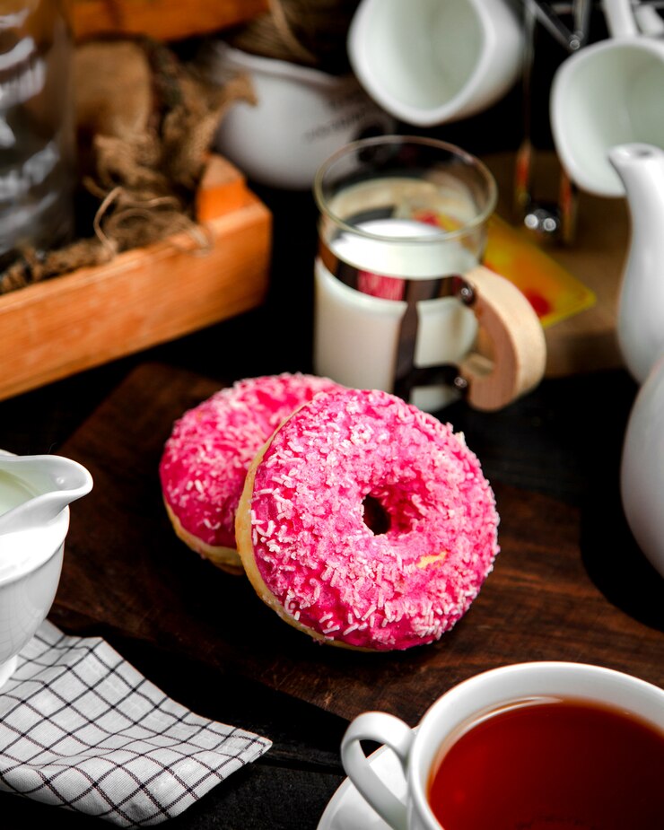 Free Photo a pair of donuts with pink cream and candies